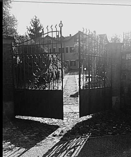 a black and white photo of an open gate at Villa Le Vignole in Ameno
