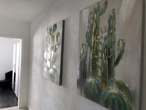 two framed pictures of flowers on a wall at Haus Frauken in Grömitz