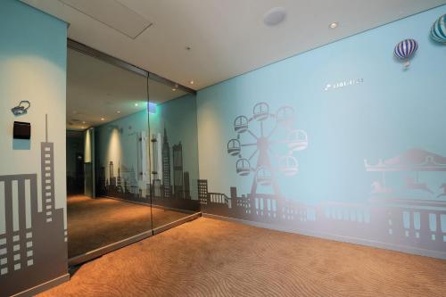 a room with a wall with a mural of a city at Green World Hotel - Zhonghua in Taipei