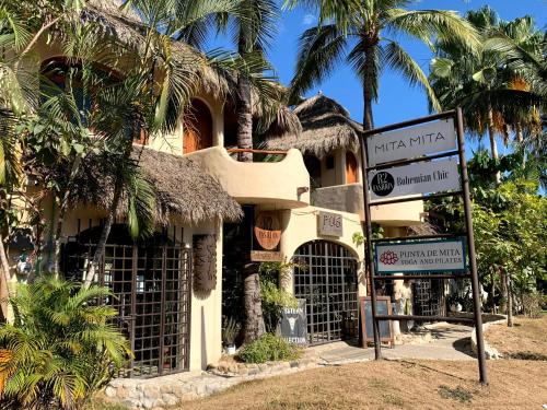 a building with a sign in front of it at Suites de Mita - Boutique Hotel in Punta Mita