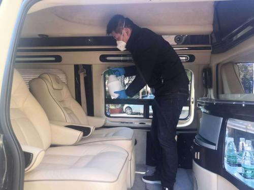 a man is standing in the back of a van at Shanghai Menglong Hotel Management in Shanghai