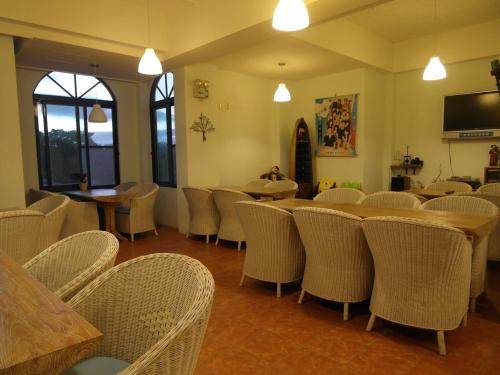 a room with chairs and a table and a room with tables and chairs at Morpheus B&B in Kenting