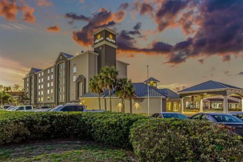 a building with a clock tower in a parking lot at La Quinta Inn & Suites by Wyndham Panama City in Panama City