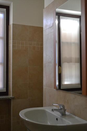 a bathroom with a sink and a mirror at La Locanda di Valbella in Asti