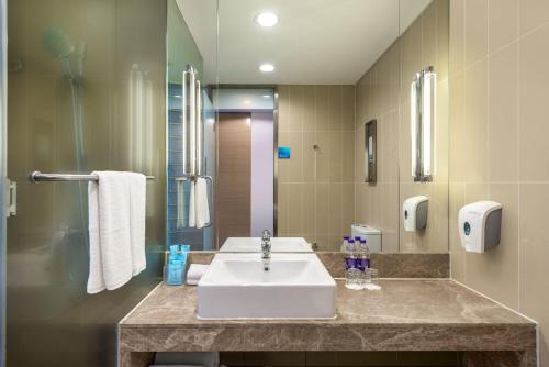 a bathroom with a sink and a shower at Holiday Inn Express Beijing Yizhuang by IHG - Taxi 1 Hour to International Airport and 800 Meters to the Nearby Subway in Daxing