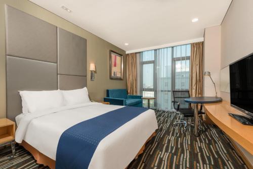 a hotel room with a bed and a television at Holiday Inn Express Beijing Yizhuang by IHG - Taxi 1 Hour to International Airport and 800 Meters to the Nearby Subway in Daxing