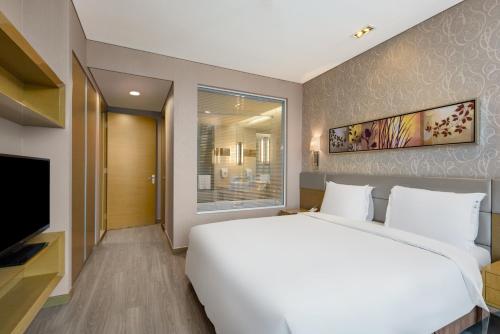 a bedroom with a large white bed and a television at Holiday Inn Express Beijing Yizhuang by IHG - Taxi 1 Hour to International Airport and 800 Meters to the Nearby Subway in Daxing