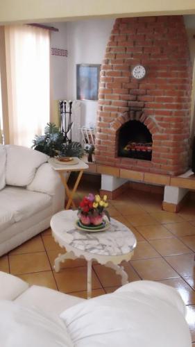 a living room with a brick fireplace at Welcome To Casa OLE Playas de Tijuana 5-Rooms 14-Guests close to Shoping Center & Beach in Tijuana