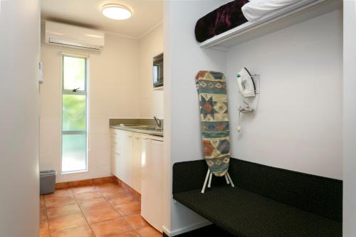 a small kitchen with a bench in a room at Great Lake Motel Taupo in Taupo