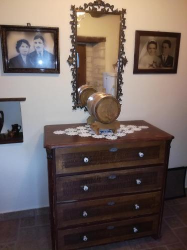 a dresser with a mirror on top of it at Hiža Golubić in Vinica