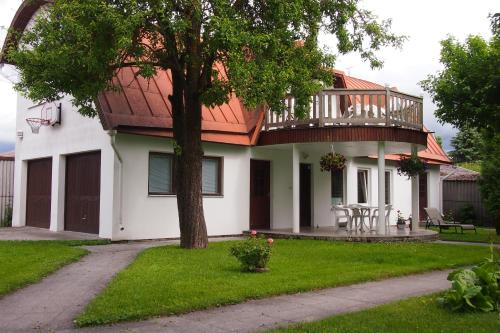 a house with a deck on top of it at Männi Peremaja in Haapsalu