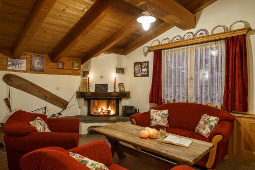 a living room with two couches and a fireplace at Hotel Silvapina in Klosters