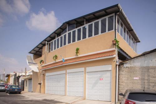 a building with two garage doors on a street at Euro Hostal in Guatemala