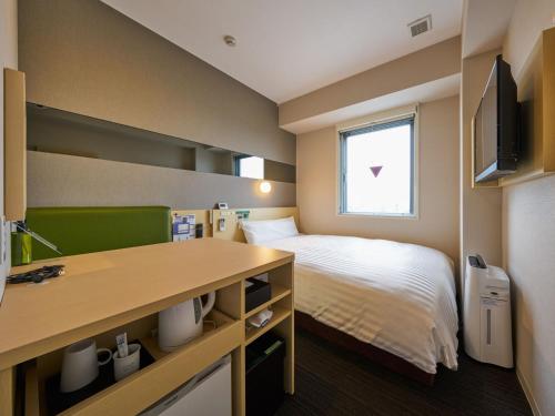 Ένα ή περισσότερα κρεβάτια σε δωμάτιο στο Super Hotel Kashima