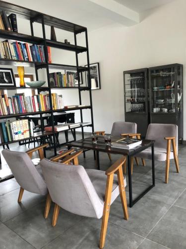 a living room with a table and chairs and bookshelves at Centrum Łąkowa 1 in Radków