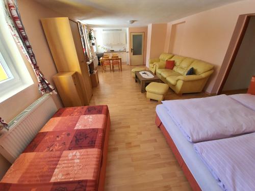a bedroom with two beds and a living room at Ubytování U Šustrů in Horní Maršov