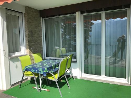 a table and two chairs on a porch with a table at Casa Franceschini in Locarno