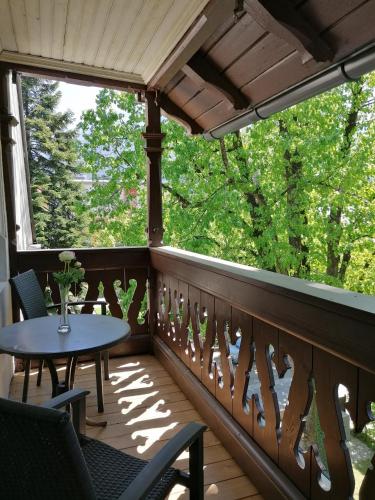 a balcony with a table and chairs and a window at Villa Steiermark in Bad Reichenhall