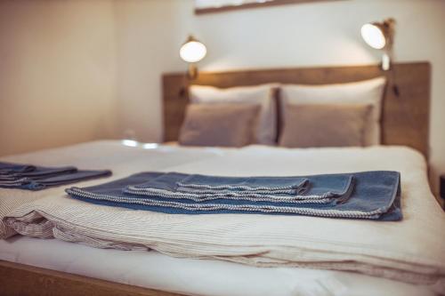 a bed with a pair of jeans on it at Na Kozím plácku in Jindrichuv Hradec