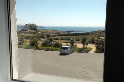 a view of a car parked in a parking lot at PLAS DARIEN-3 BED APT- SEA VIEWS - SLEEPS 5 in Trearddur