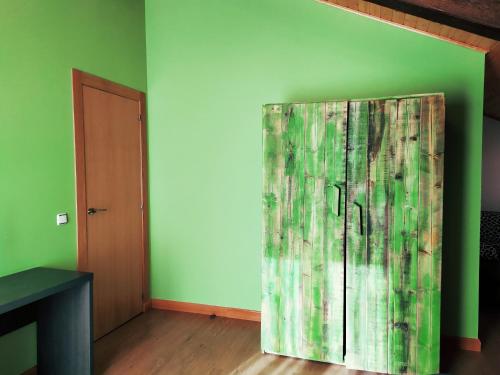 a door in a room with a green wall at Casas rurales en Fanlo y Valle Vio in Fanlo del Valle de Vío