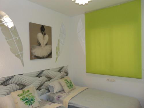 a living room with a green screen and a couch at Apartamentos varios con 2 dorm en Marina Dor , la playa de Amplaries 47 , vista lateral al mar in Oropesa del Mar