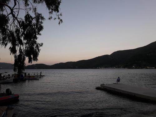a person standing on a dock in a body of water at Ionian Trilogy Luxury Villas in Sami