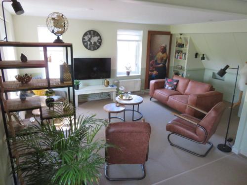 a living room with a couch and a table at Holiday apartment with free parking Boven Jan Enkhuizen in Enkhuizen