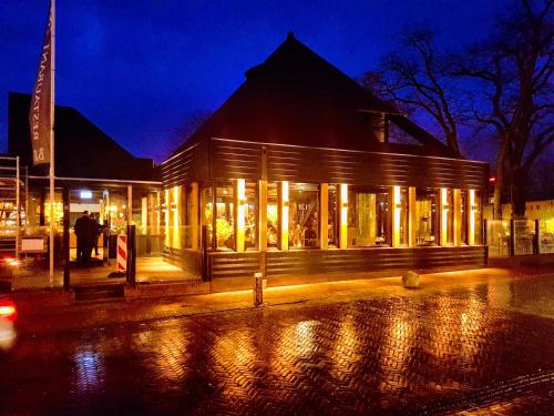 a building with lights in front of it at night at Hotel Bieze in Borger