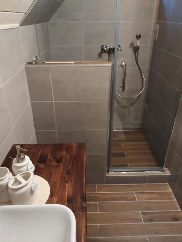 a bathroom with a shower and a toilet and a tub at Chata Bačova skala in Liptovský Ján
