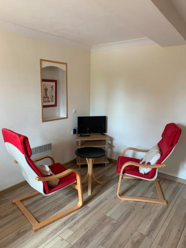 a living room with two chairs and a desk at LA BASTIDE DU GINESTE - Poppys in Flayosc