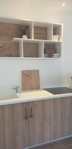 a kitchen with a sink and a counter top at Opaline Baie de somme in Ault