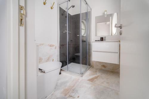 La salle de bains est pourvue d'une douche en verre et de toilettes. dans l'établissement Nomad's By Sta Catarina Flats - 3BED Porto, à Porto