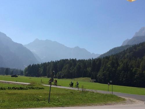 a group of people riding bikes down a road at Apartments Blažič in Kranjska Gora