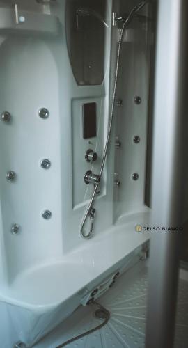 a white bathroom with a mirror and a sink at Gelso Bianco Country Resort in Savignano sul Panaro