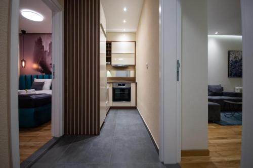 a hallway leading to a kitchen and a living room at Belgrade CITY CENTER Apartments in Belgrade