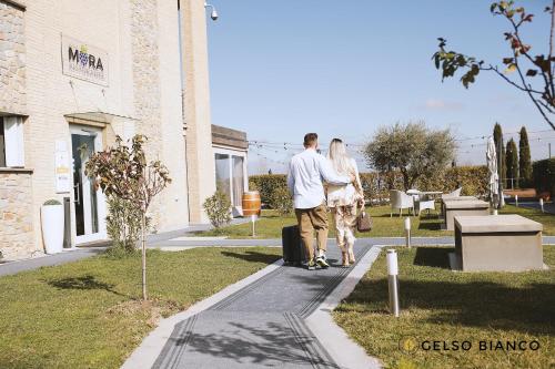 a man and a woman standing outside of a building at Gelso Bianco Country Resort in Savignano sul Panaro