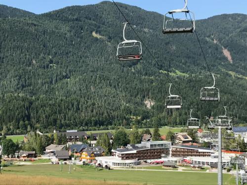 a group of ski lifts flying over a resort at Apartments Blažič in Kranjska Gora