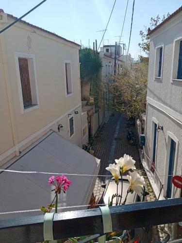 a view from a balcony with flowers on the ledge at Aegina's Flowers house in Aegina Town