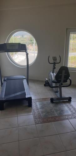 a gym with two exercise bikes and a window at Alexia's Apartments in Rio
