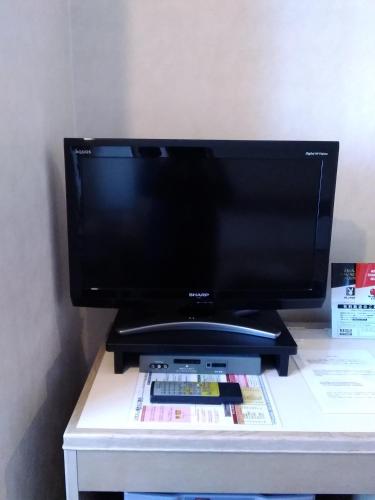 a flat screen tv sitting on top of a table at Grand Hotel Kanachu Hadano in Hadano