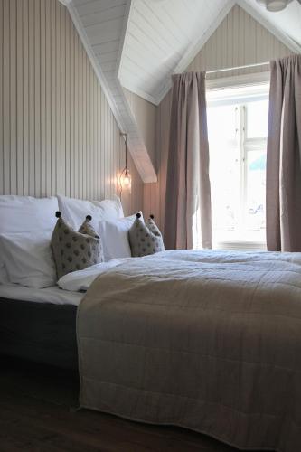 a bedroom with a large bed with a window at Petrines Gjestgiveri in Norddal