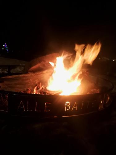 a fire ball in the dark with flames at Agriturismo Alle Baite in Branzi