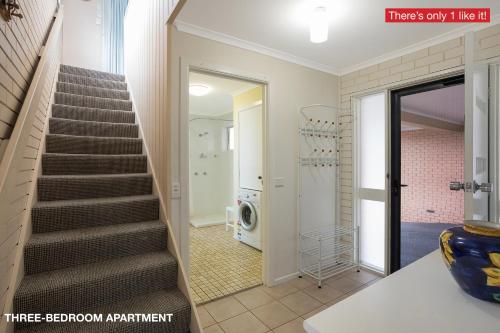 a bathroom with a stairway leading to the stairs at Panoramic Townhouses by Lisa in Merimbula