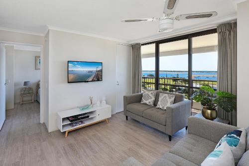 a living room with a couch and a table at Palmerston Tower in Gold Coast