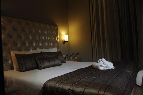 a hotel room with a bed with towels on it at Kristonia Hotel Suites in Kilkís