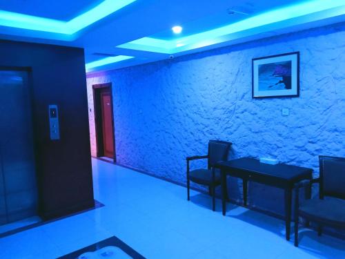 a room with a table and chairs and a brick wall at Grand Inn Hotel in Muscat