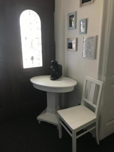 a bathroom with a sink and a chair and a window at Apartmán U Borovice in Rychnov nad Kněžnou