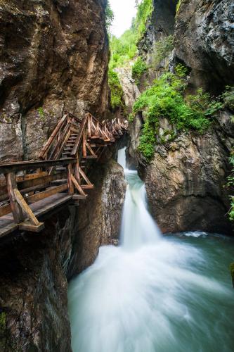 a bridge over a river in a canyon at Auhof Wirtshaus & Suiten in Kaprun
