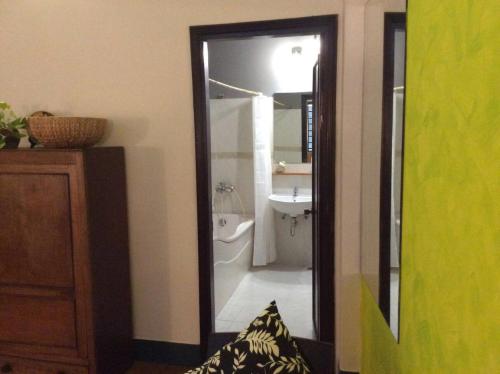a bathroom with a shower and a sink and a mirror at Domino Homestay in Ho Chi Minh City